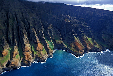 The towering eroded seacliffs of the famous NA PALI COAST seen by helicopter, the easiest way to see this inaccessible scenic wonder, Kauai, Hawaii, USA