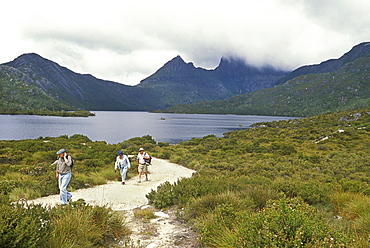 Hikers at Dove Lake below 1545m Cradle Mountain in the World Heritage Cradle Mountain-Lake St. Clair National Park, Tasmania, Australia, Pacific