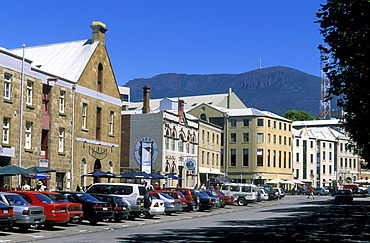 Sandstone warehouses converted to cafes, galleries and shops, with 1270m Mount Wellington beyond, at popular Salamanca Place,  Hobart, Tasmania, Australia, Pacific