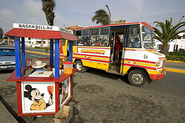 Bus passing drinks stall at the popular far north coast fishing & surfing village of Huanchaco, near Trujillo, Peru, South America