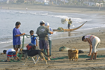 Fishing family on the beach at the popular far north coast fishing & surfing village of Huanchaco, near Trujillo, Peru, South America.