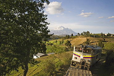 Bus and the famous El Nariz del Diablo (The Devil's Nose) train en route to Riobamba with Chimborazo volcano in the distance, Riobamba, Chimborazo Province, Central Highlands, Ecuador, South America