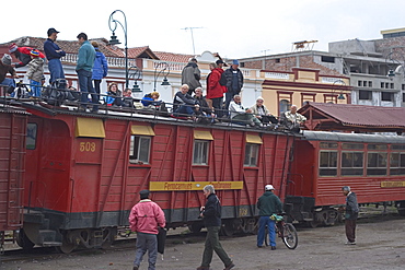 Roof-top tourists await the departure of the famous train ride to the Nariz del Diablo (The Devil's Nose) from this major transport and tourist hub, Riobamba, Chimborazo Province, Central Highlands, Ecuador, South America