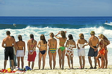 Attractive young people in swim wear lined up for a photo on Sydney's iconic Bondi Beach in the Eastern Suburbs, Bondi, New South Wales, Australia, Pacific