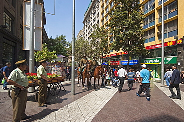 Police on horseback and people on pedestrianised Paseo Huerfanos in the heart of the commercial centre, Santiago, Chile, South America