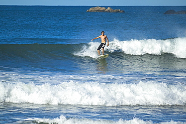 Surfer on a wave, Playa Guiones beach, Nosara, Nicoya Peninsula, Guanacaste Province, Costa Rica, Central America