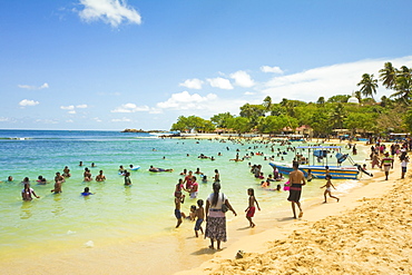 Sri Lankans swimming at the west end of this popular resort and beach, wrecked by the 2004 tsunami, Unawatuna, Galle, Sri Lanka, Asia