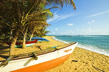 Fishing boats at the east end of the south coast whale watch surf beach at Mirissa, near Matara, Southern Province, Sri Lanka, Asia