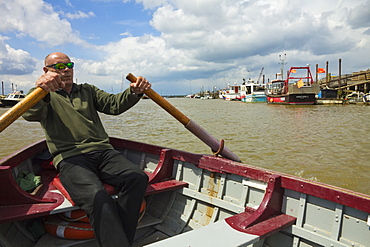 Man rowing the ferry to Walberswick over the River Blyth, a service dating back to the Middle Ages, Southwold, Suffolk, England, United Kingdom, Europe