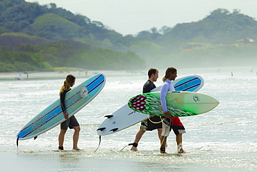 Couple going for surf lesson at Playa Guiones beach, Nosara, Nicoya Peninsula, Guanacaste Province, Costa Rica, Central America