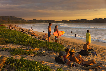 Traditional sunset gathering on Playa Guiones beach, Nosara, Nicoya Peninsula, Guanacaste Province, Costa Rica, Central America