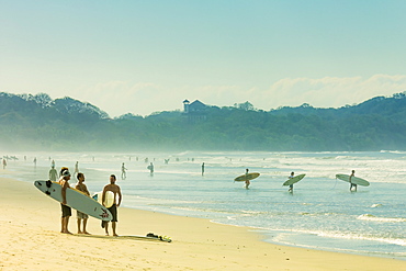 Surfers on Playa Guiones beach, Nosara, Nicoya Peninsula, Guanacaste Province, Costa Rica, Central America