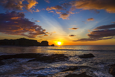 Sunset by the southern headland of beautiful Playa Pelada beach, Nosara, Nicoya Peninsula, Guanacaste Province, Costa Rica