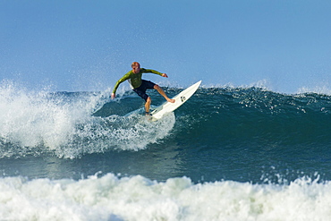 Surfer on shortboard riding wave at popular Playa Guiones surf beach, Nosara, Nicoya Peninsula, Guanacaste Province, Costa Rica, Central America