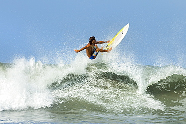 Surfer on shortboard riding wave at popular Playa Guiones surf beach, Nosara, Nicoya Peninsula, Guanacaste Province, Costa Rica, Central America