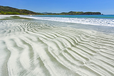 Bands of light sand grains sorted from heavier dark minerals in intertidal zone at Playa Carrillo, Nicoya Peninsula, Costa Rica, Central America