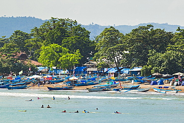 Outrigger fishing boats at the town beach of this major south coast resort, Pangandaran, West Java, Java, Indonesia, Southeast Asia, Asia