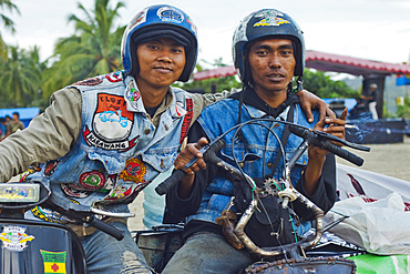 Young men in helmets at a scooter enthusiasts' meet in this major south coast resort, Pangandaran, West Java, Java, Indonesia, Southeast Asia, Asia