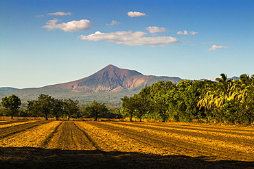 Fields north of Leon and Volcan Telica, one of the country's most active volcanoes, in the North West volcanic chain, Leon, Nicaragua, Central America