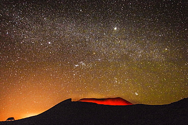 Glowing active volcanic crater of Volcan Telica on a starry night, with the Milky Way, Orion and the Pleiades, Leon, Nicaragua, Central America