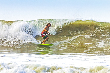 Middle-aged man surfing at this hip resort near Mal Pais, far south  of Nicoya Peninsula, Santa Teresa, Puntarenas, Costa Rica, Central America