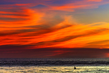 Lone surfer and sunset clouds off Playa Hermosa surf beach, southern Nicoya Peninsula, Santa Teresa, Puntarenas, Costa Rica, Central America