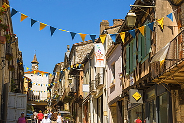 Restaurants and shops on steep Rue St. Pierre in this attractive south western bastide town, Monflanquin, Lot-et-Garonne, France, Europe