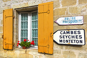 Shuttered window and signs in this old village on the Dropt River near Duras, Lot-et-Garonne, Aquitaine, France, Europe