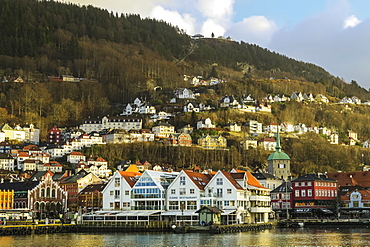 The castellated Kjottbasaren shopping centre on left and the Fjord Restaurant on the Bryggen waterfront, UNESCO World Heritage Site, Bergen, Hordaland, Norway, Scandinavia, Europe