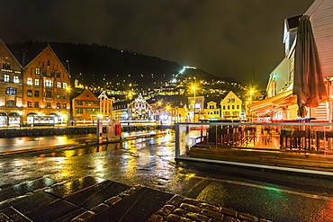 The Fjord Restaurant by Vagen Harbour with the Bryggen waterfront and funicular rail beyond, at night, Bergen, Hordaland, Norway, Scandinavia, Europe