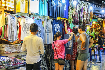 Girl tourists browse souvenir clothes in the Art Center Night Market in the centre of this NW tourist town, Siem Reap, Cambodia, Indochina, Southeast Asia, Asia