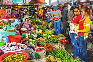 Girls at vegetable stall at the busy central market in this old fomerly French colonial river port city, Kampot, Cambodia, Indochina, Southeast Asia, Asia