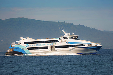 The 38 metre Majestic Kawanua II aluminium fast ferry departing the capital to the distant northern island of Siau, Manado, North Sulawesi, Indonesia, Southeast Asia, Asia