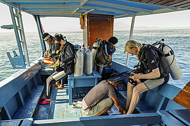 Divers prepare on boat off this popular coral fringed island and scuba and snorkel destination, Bunaken, North Sulawesi, Indonesia, Southeast Asia, Asia