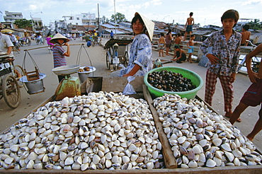 Man selling shellfish and snails on bridge, Ho Chi Minh City (formerly Saigon), Vietnam, Indochina, Southeast Asia, Asia