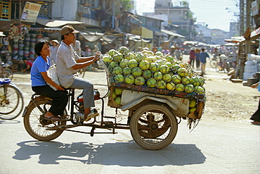 Melons being transported on three wheeler Xe Lam in downtown area, Ho Chi Minh City (formerly Saigon), Vietnam, Indochina, Southeast Asia, Asia