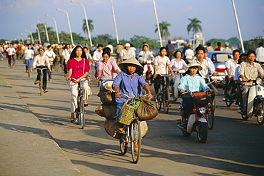 Cyclists in morning rush hour on Phu Xuan bridge, Hue, Vietnam, Indochina, Southeast Asia, Asia