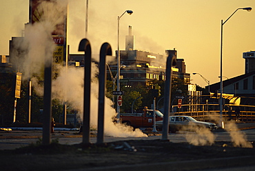 Steam escaping from below street at dusk, Hamtramck, a Polish inner city area, Detroit, Michigan, United States of America, North America