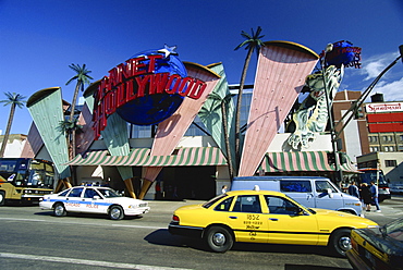 Planet Hollywood restaurant sign and passing taxis, Chicago, Illinois, United States of America, North America