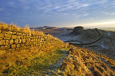 Sunrise and Hadrian's Wall National Trail in winter, looking to Housesteads Fort, Hadrian's Wall, UNESCO World Heritage Site, Northumberland, England, United Kingdom, Europe