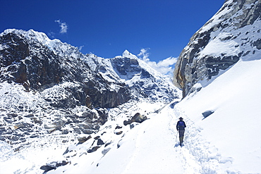 Trekker walking over Cho La Pass with Lobuche West and East on left side, Solukhumbu District, Nepal, Himalayas, Asia 