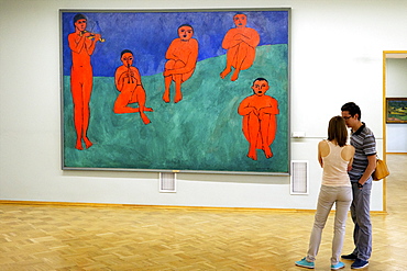 Young couple admire Music, by Henri Matisse painted in 1910, State Hermitage Museum, St. Petersburg, Russia, Europe