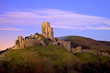 The ruins of the 11th century Corfe Castle after sunset, near Wareham, Isle of Purbeck, Dorset, England, United Kingdom. Europe