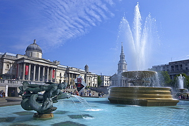 Tritons and dolphin fountain with the Olympic digital countdown clock and the National Gallery, Trafalgar Square, London, England, United Kingdom, Europe