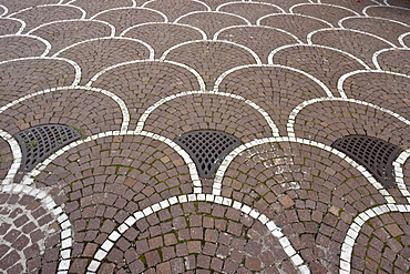 Bicolour cobble fan pattern paving with bespoke manhole covers, EUR district, Rome, Latium, Italy, Europe