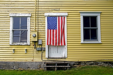 Yellow barn, American flag, Owls Head colony, Maine, New England, USA