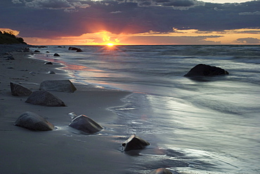 Stones on the northern beach at sunset, Ruegen island, Mecklenburg-Western Pomerania, Germany, Europe