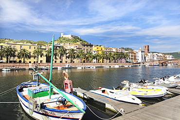 Boats on the Temo River with a palm-lined promenade, Bosa, Oristano Province, Sardinia, Italy, Europe