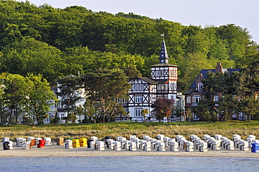 Lined up beach chairs on the sandy beach of the Baltic resort Binz, in the back historical beach villas with spa architecture, Ruegen island, Mecklenburg-Western Pomerania, Germany, Europe