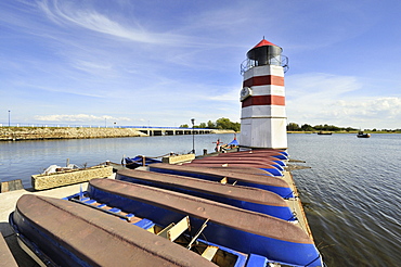 Boat harbor with lighthouse on Ummanz island, in the back the bridge connecting Ummanz with Gingst on Ruegen island, Ruegen district, Mecklenburg-Western Pomerania, Germany, Europe